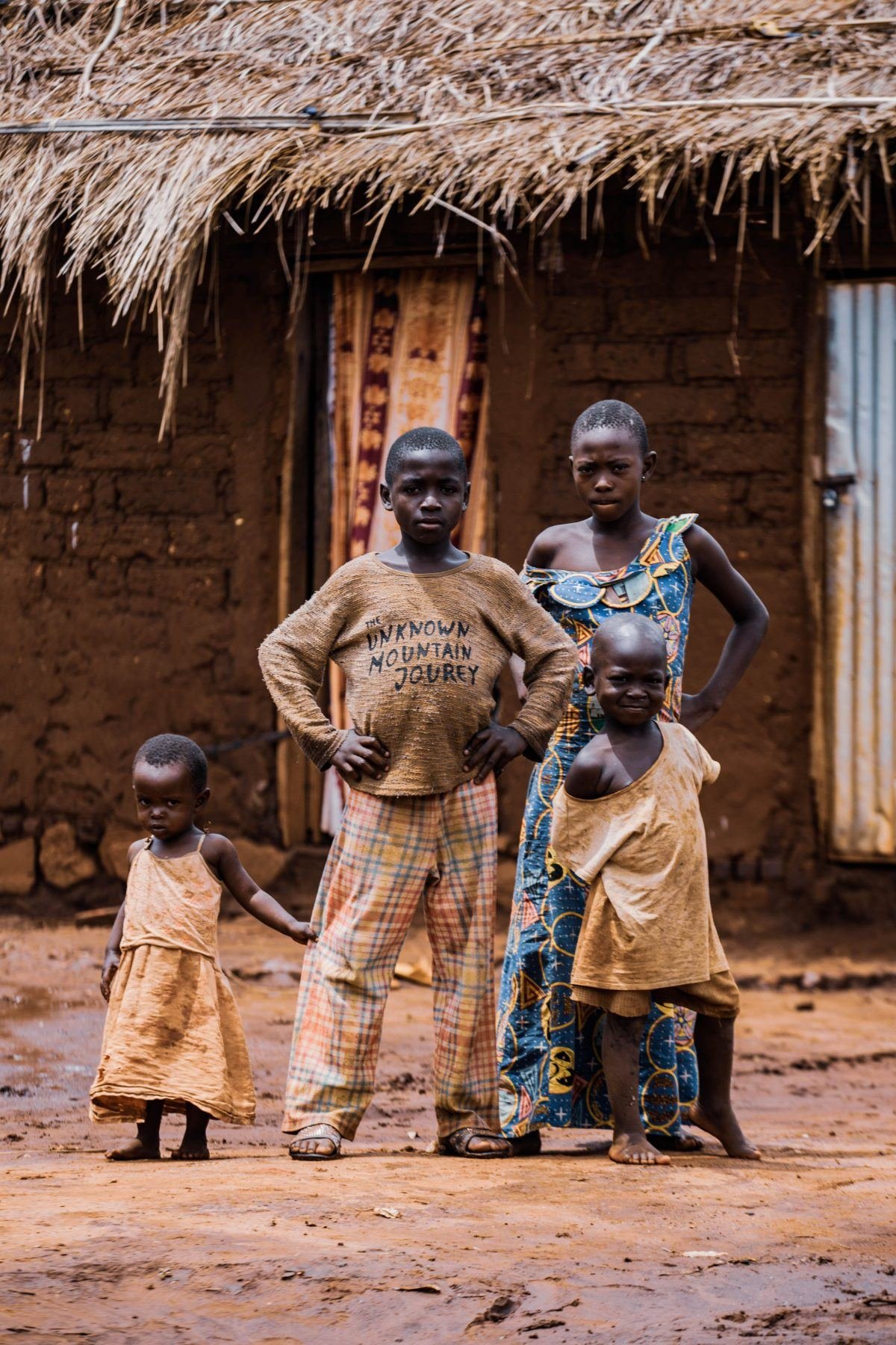 Children in front of a mud-built house